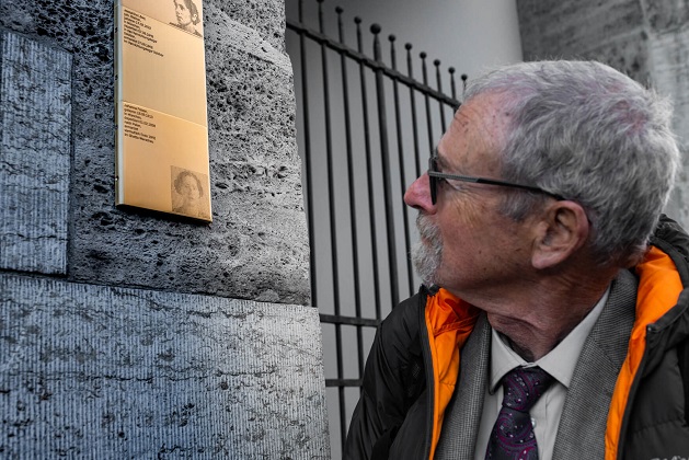 Michael Felsen next to the Memorial Sign for his aunt Johanna Felsen