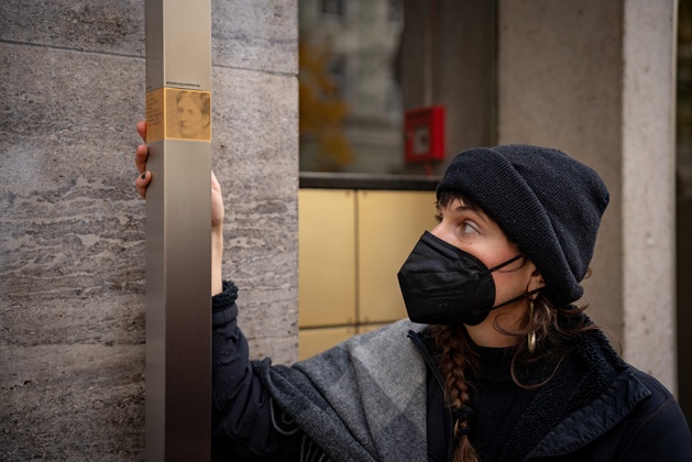A relative installs the Memorial Sign for Flora Fromm