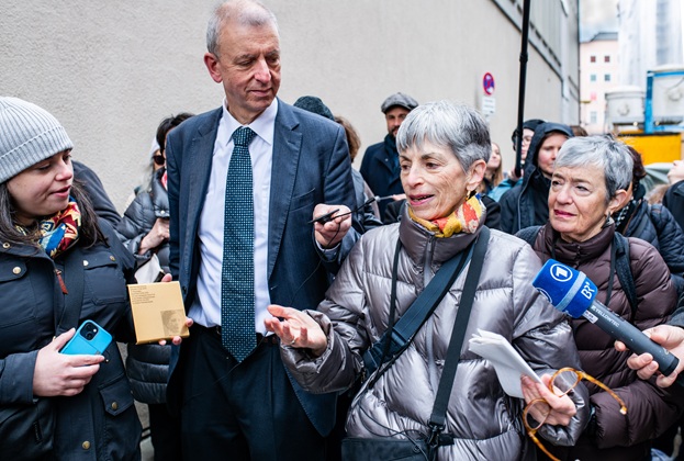 Naomi Karp, Ellen Kandell, and other relatives show the Memorial Sign for Hermine Bernheimer
