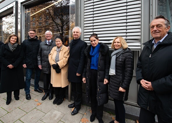 Gruop picture with the Memorial Sign for Dr Fritz Zieglwallner