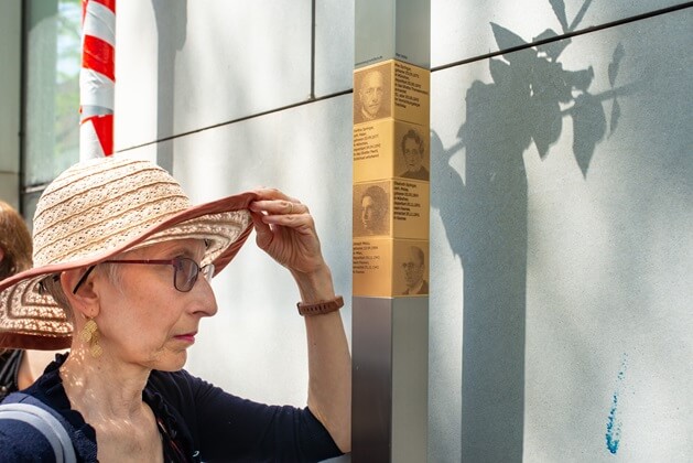 Relative next to the Memorial Signs for the Springer family and Jakob Weiss