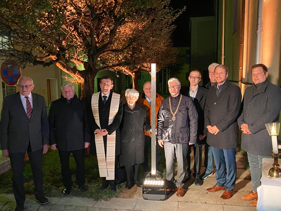 Group picture with the Memorial Sign for Johann Baptist Huber