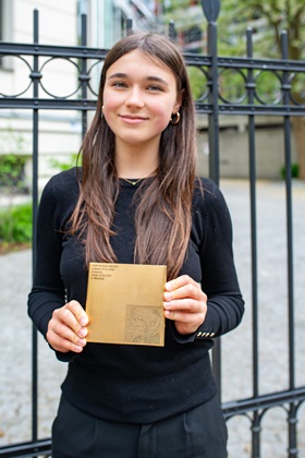 Student with the Memorial Sign for Adolf Abraham Richard