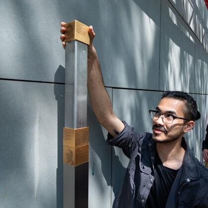 A relative installing the Memorial Sign for Dorline Springer