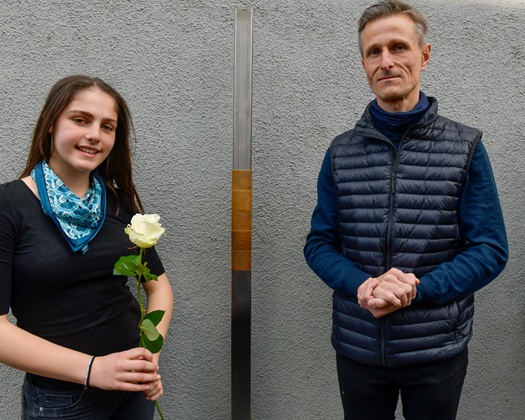 Schülerin und Jörg Spengler, Bezirksausschuss Au - Haidhausen, neben dem Erinnerungszeichen für Alfred Holzer