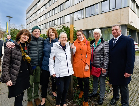Relatives and guests in front of the Memorial Sign for Minna Hirschberg